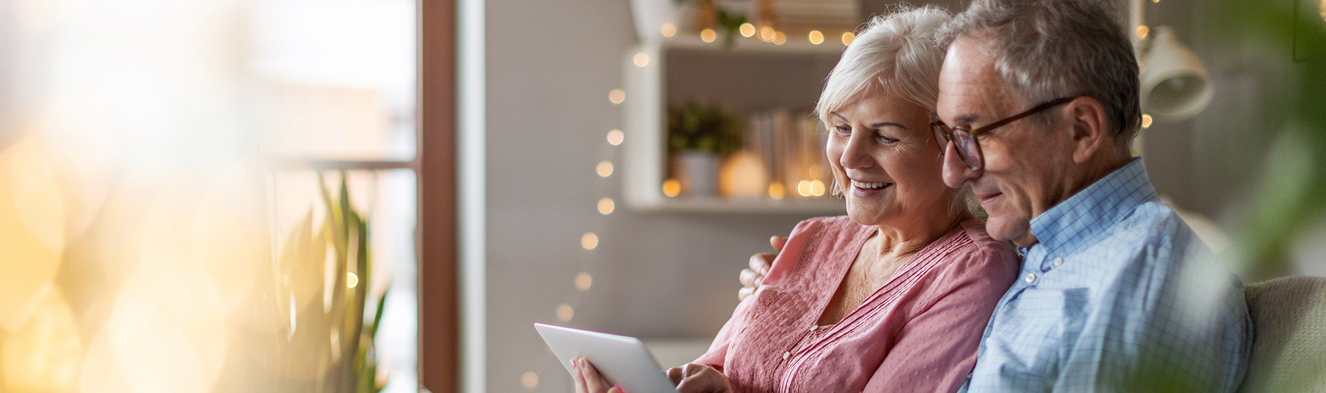 Mature couple using a laptop while relaxing at home