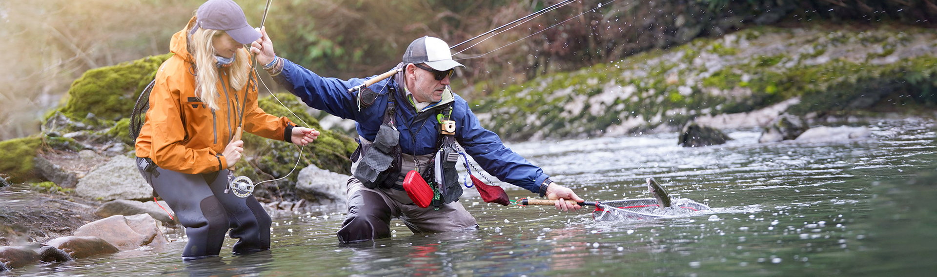 Middle aged couple fly fishing